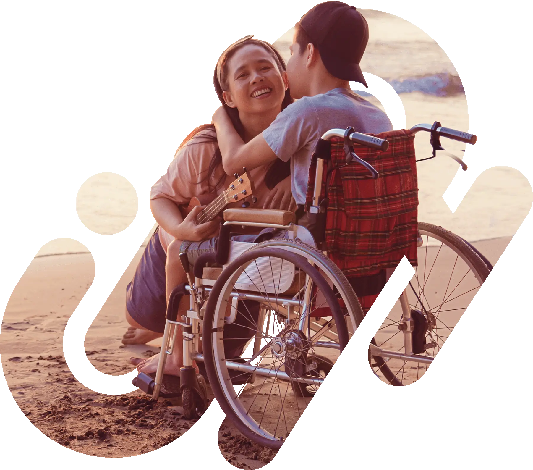 Man in wheelchair with women at the beach