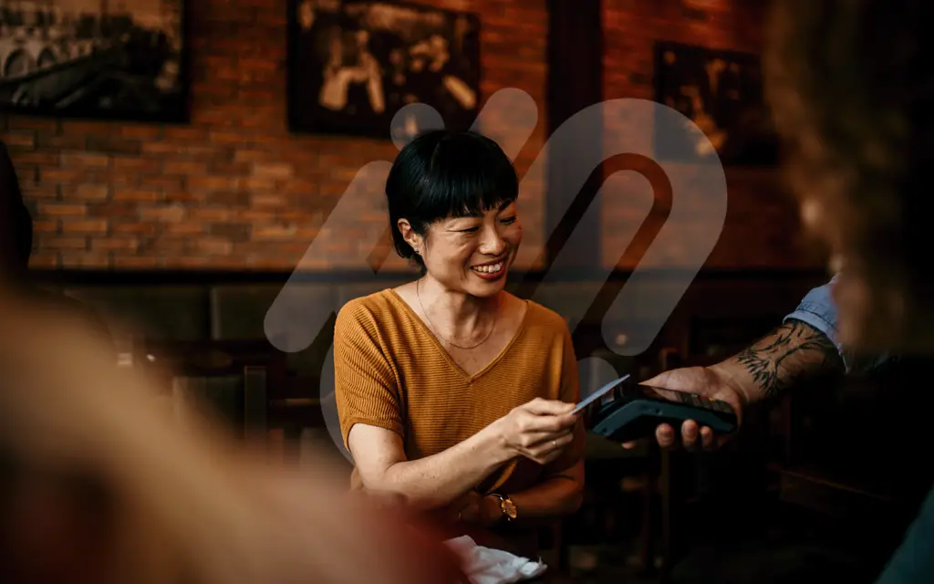 Woman Paying bill in Restaurant on card