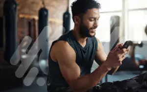 Man at gym on his phone
