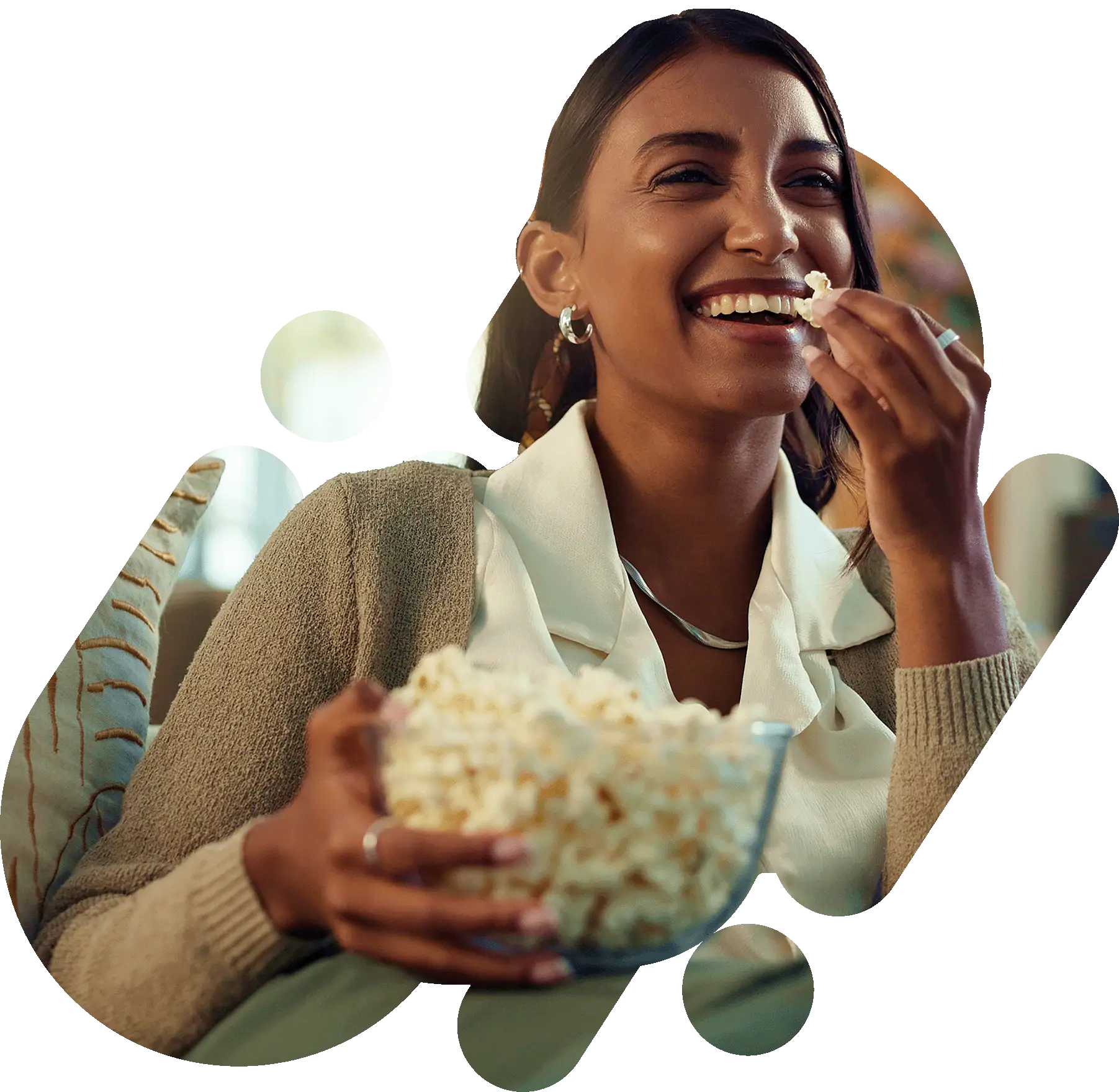 Woman eating popcorn on the sofa